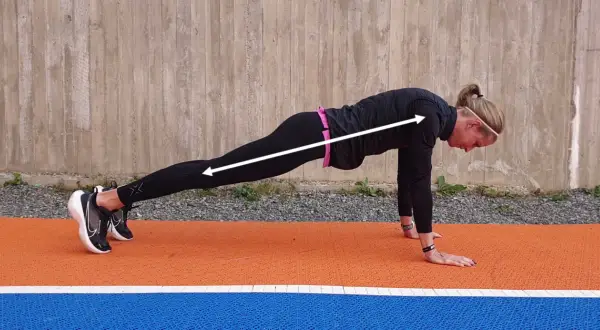 En kvinna i plankposition, redo för mountain climbers.