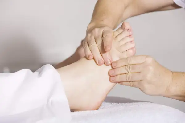 Close-up of hands massaging a foot.